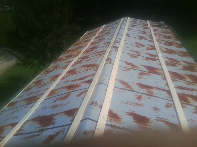 Rusted metal roof panels with new wood purlins before replacement — Storm Damage Roof Repair in Greenleaf by Roofing Brothers